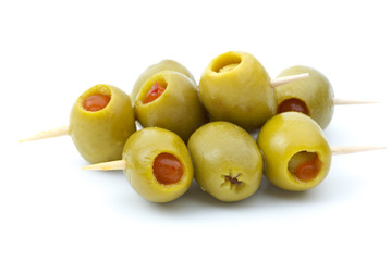 Some olives stuffed with pepper on a wooden toothpicks