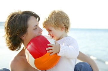 Mother and son on the sea, football ball