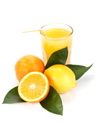 Fruits with green leaves and glass of juice