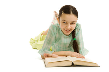Lying girl with the book smiles