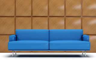blue sofa with decorated wall with square panels of wood