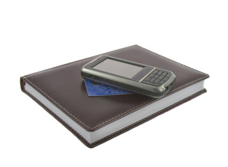 Closeup of brown notebook.credit kard and mobile phone on it iso