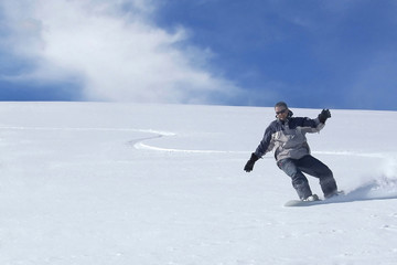 Fototapeta na wymiar Snowboarder action wave in powder snow