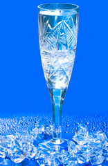 Glass with water and ice over blue