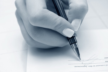 Businesswoman signing the contract.