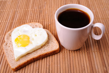 Fried eggs and cup of black coffee