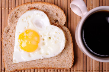 Fried eggs and cup of black coffee