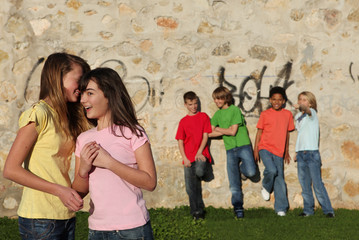 group of adolescents kids interacting and whispering