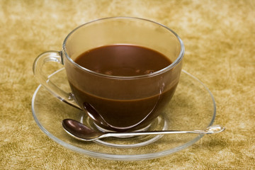 cup with coffee over brown background