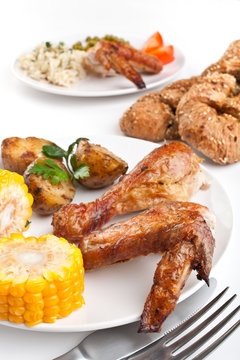 roasted chicken wings with potatoes, tomatoes, corn and rice