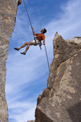 Rock climber rappelling.