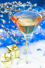 glass with champagne and gift boxes