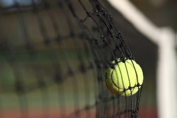 Tennis ball in the net