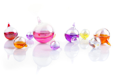 reflections - set of glass containers filled with colored liquid