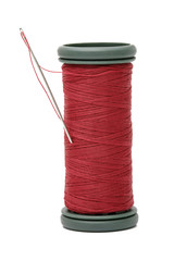 Needle on reel of thread