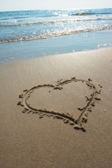 Heart drawn on sand, seacoast