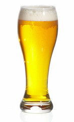 Glass of beer close-up with froth over white background