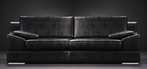An empty sofa isolated on a black background