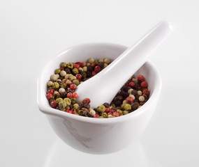 Mix of peppercorns in a porcelain mortar