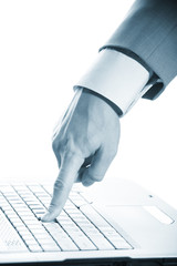 Close-up of  hand touching computer keys during work