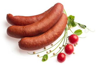 Smoked sausages decorated with tomatoes, onion, pepper