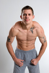 Fototapeta premium Tattooed Man Flexing Muscles