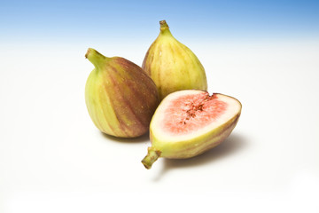 Fresh figs on a blue studio background.