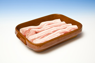 belly pork isolated on a blue studio background.