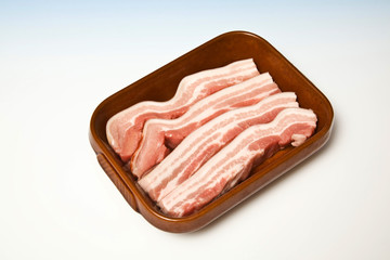 Roasting dish with raw belly pork.