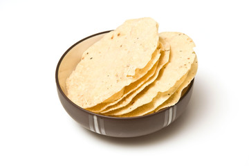 bowl of Pappadums isolated on a white studio background