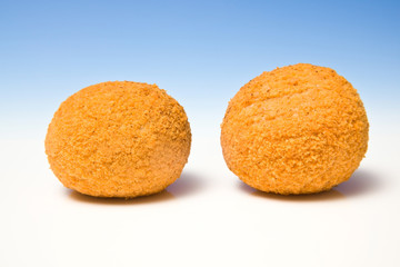 Scotch eggs on a blue studio background