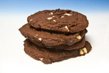 Chocolate cookies on a blue studio background.