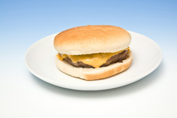 Cheeseburger on a graduated blue studio background.
