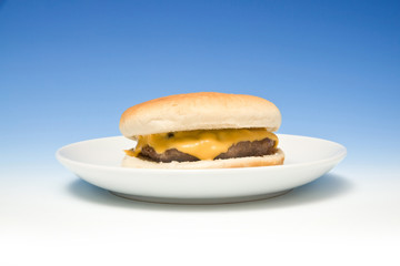 Cheeseburger on a graduated blue studio background.