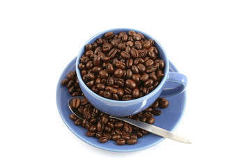cup full of coffee beans close up isolated in studio
