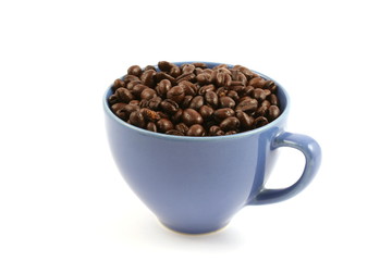 cup full of coffee beans close up isolated in studio