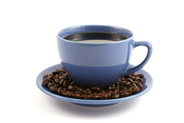 cup of coffee with coffee beans on plate