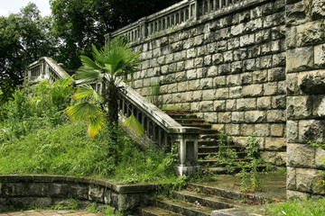 Fototapeta na wymiar ancient stages of bridge surrounded green vegetation