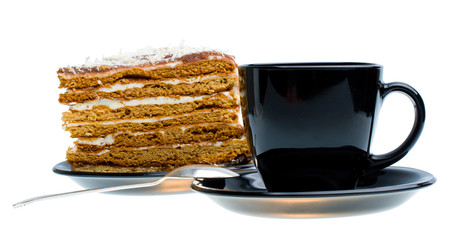 black cup and piece of honey cake