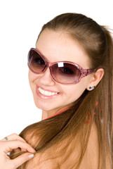 Close-up portrait of smiling young beautiful woman in sunglasses