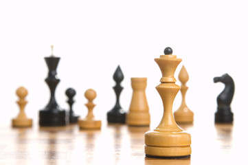 Chessmens on a chessboard, white background