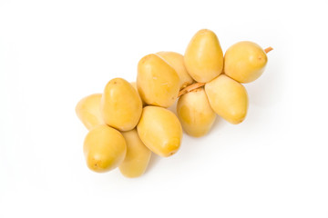 Fresh yellow dates isolated on a white studio background.