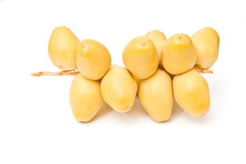 Fototapeta na wymiar Fresh yellow dates isolated on a white studio background.