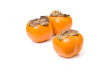 Sharon fruit isolated on a white studio background.