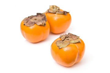 Sharon fruit isolated on a white studio background.