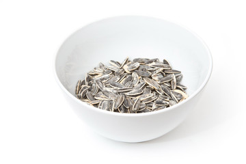 Bowl of Sunflower seeds isolated on a white studio background.
