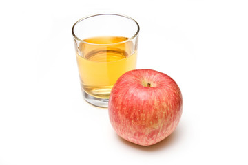 Glass of apple juice  on a white studio background.