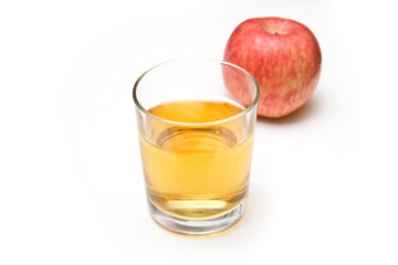 Glass of apple juice with a fuji apple