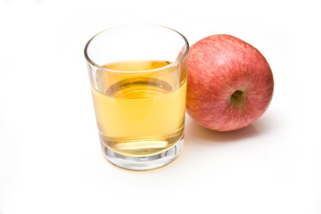 Glass of apple juice with a fuji apple
