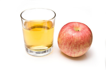 Glass of apple juice with a fuji apple